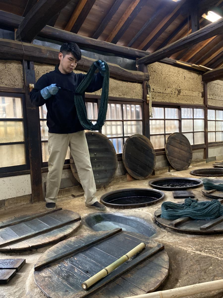 Dipping yarn in indigo vats at Yamamura Takeshi atelier