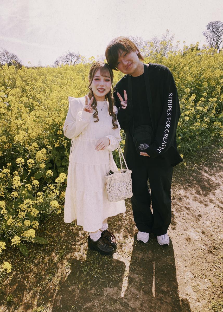 Couple amid the mustard flowers, Japan